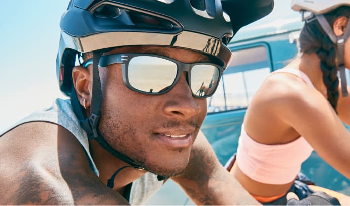 Image of a man wearing Zenni sports sunglasses while riding a bicycle.