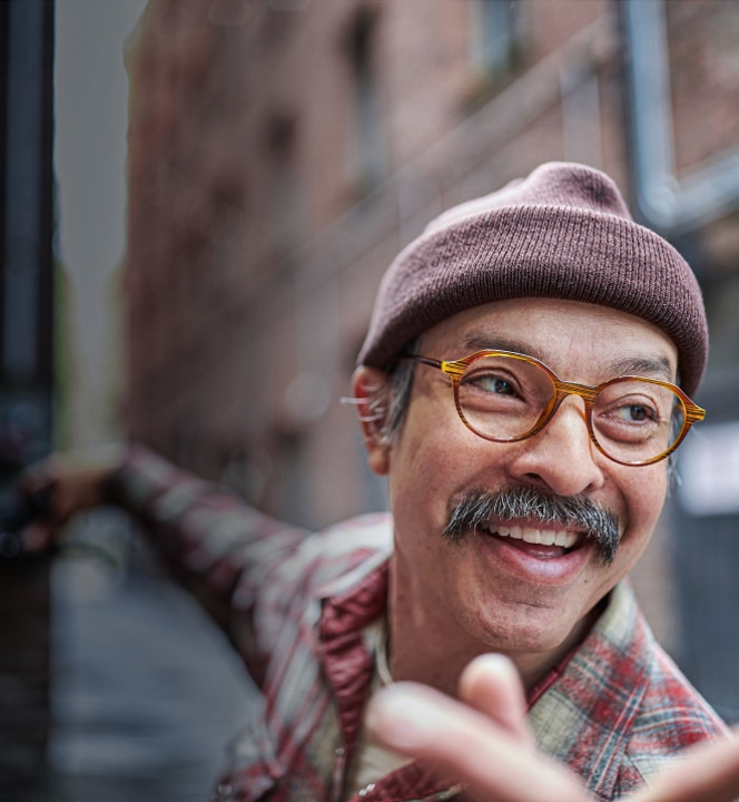 Image of a man wearing a beanie and Zenni glasses, with a big smile.