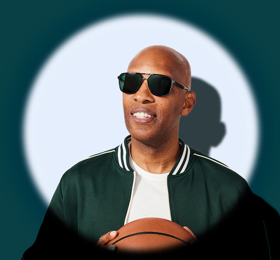 Sam Cassell holding a basketball and wearing Zenni dark aviator sunglasses, spotlighted against teal background.