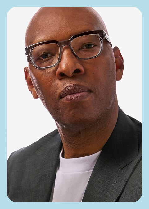 Sam Cassell wearing square brown Zenni frames against a white background.