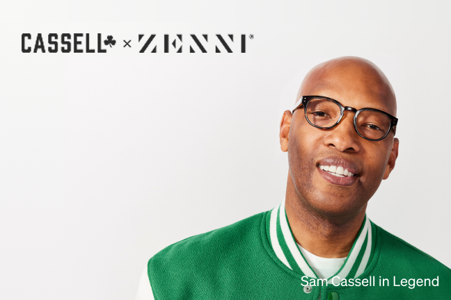 Sam Cassell is wearing black Legend glasses and a green varsity jacket, smiling against a clean white background.