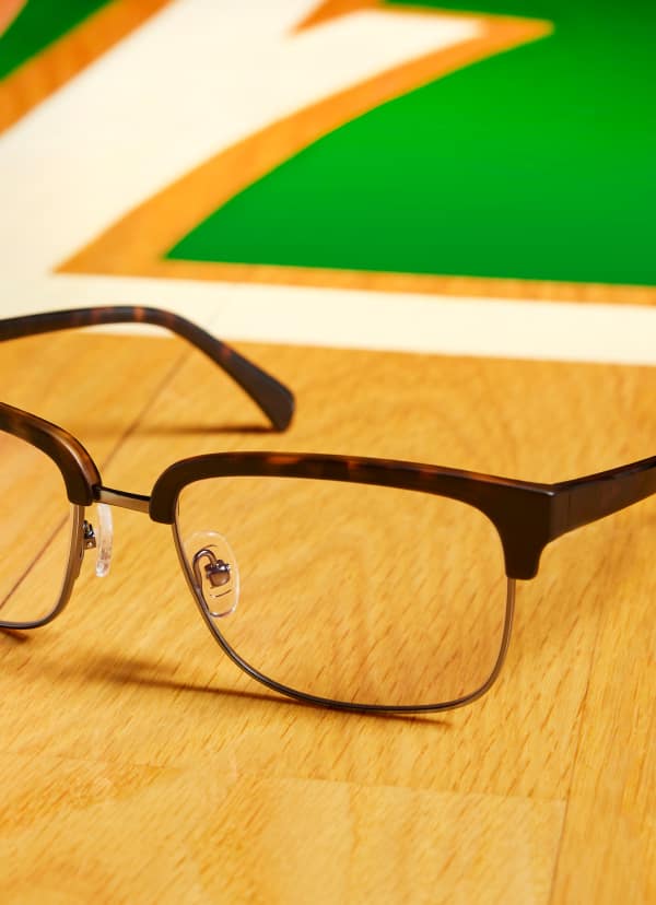 Zenni eyeglasses on basketball court floor, caption 'Bold Style Wins. ‘View product’ prompt.