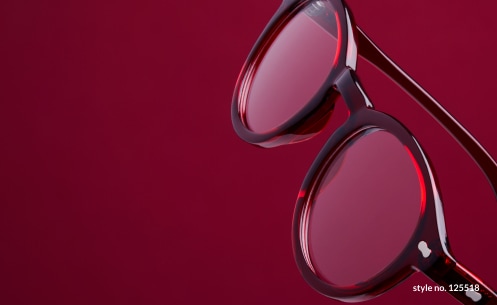 Image of Zenni round glasses #125518 against a rich red background.