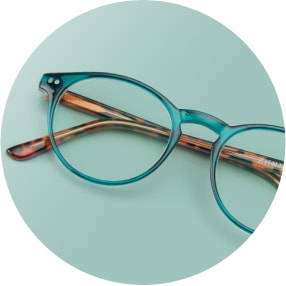 Image of a pair of green round glasses against a green background.