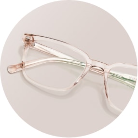 Image of a pair of beige rectangle glasses against a beige background.