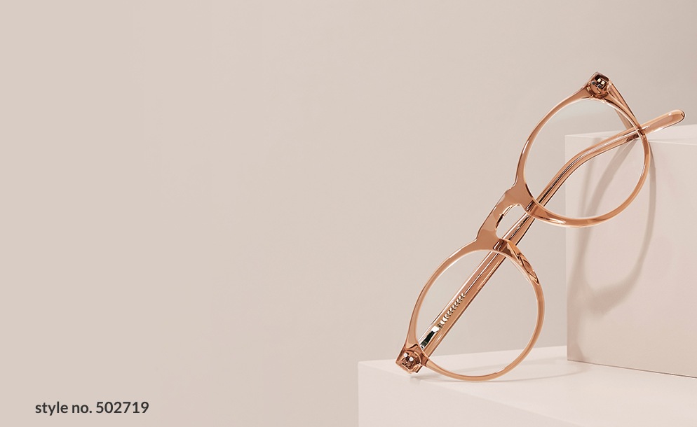 Zenni brown round clip-on set glasses #502719 displayed on light beige blocks.