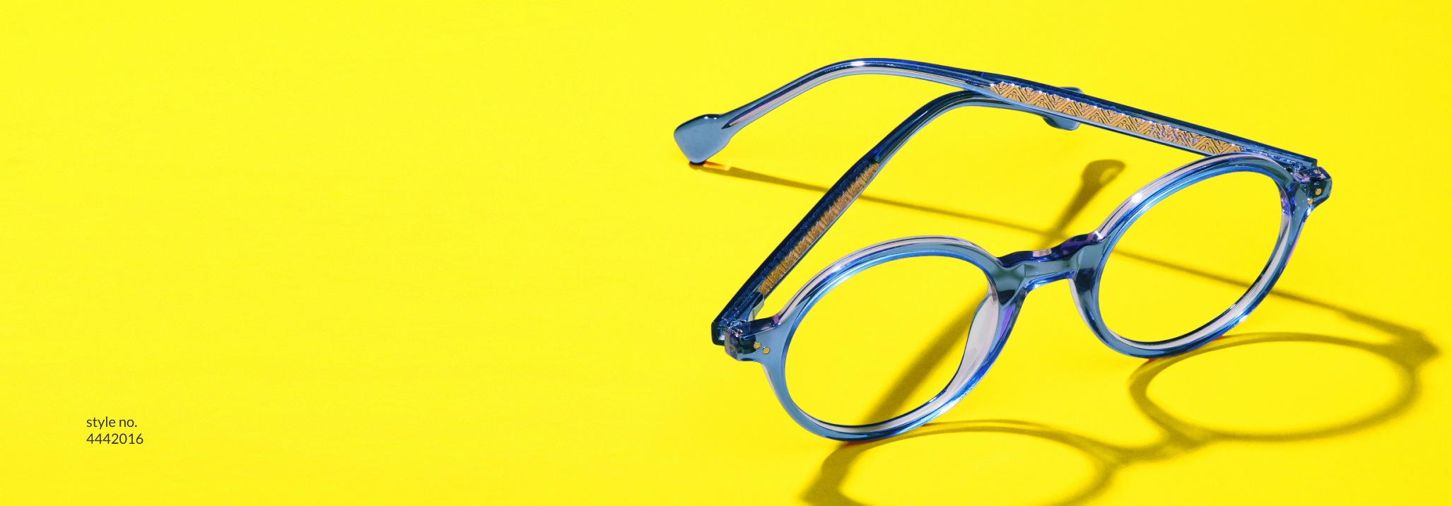 Image of Zenni glasses #4442016 against a bright yellow background, casting a shadow.