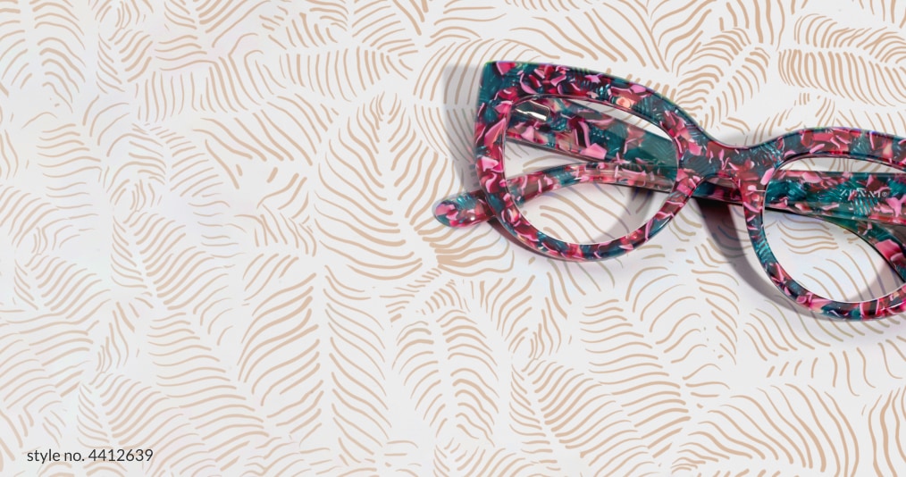 Image of Zenni green and purple floral cat-eye glasses on a brown leaf pattern background.