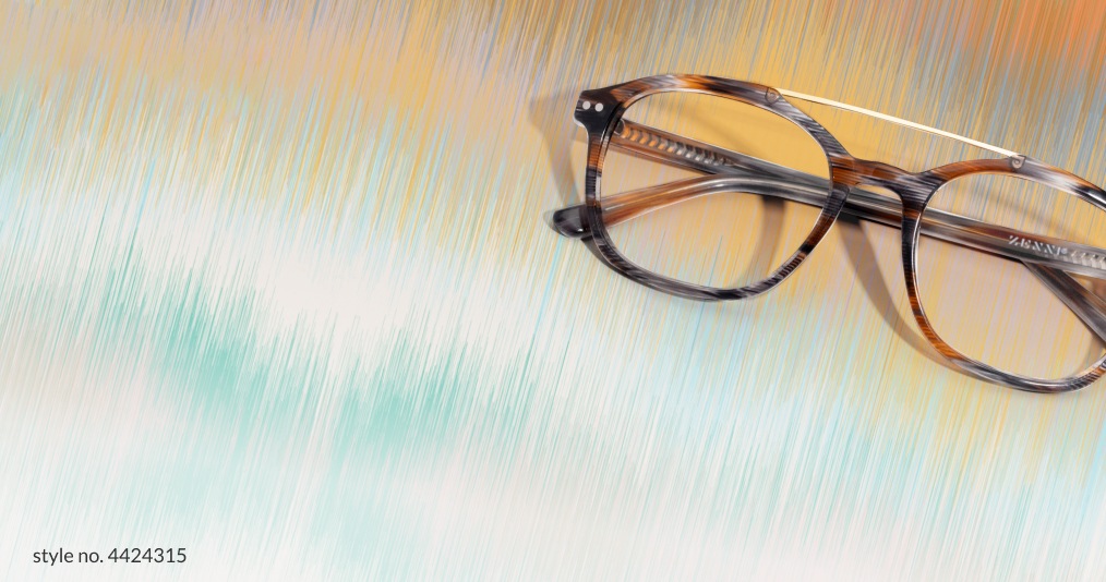 Image of Zenni brown and gray pattern glasses on a paint brush stroke background with matching color.