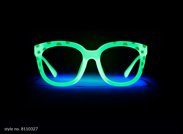 Image of Zenni glow-in-the-dark glasses #8110327, split in half; with one side in the dark glowing bright green, and the other in the light appearing pink. The dark said says ‘lights off’ and the light side says ‘lights on’.