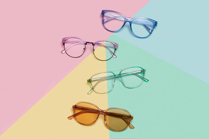 Blue transparent square, pink transparent browline, green transparent aviator, and orange transparent glasses with orange-tinted lenses.