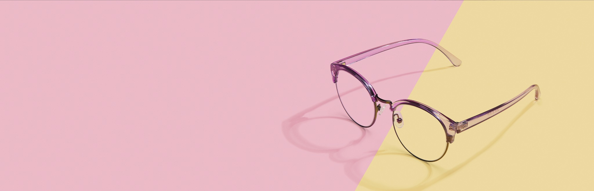 Translucent pink browline glasses with a pink and yellow background.