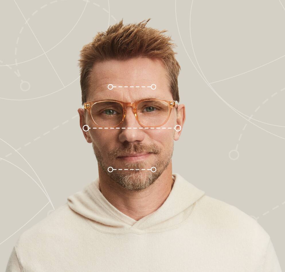 Image of a man wearing Zenni glasses, with dotted lines over his face showing the various dimensions of his face. 