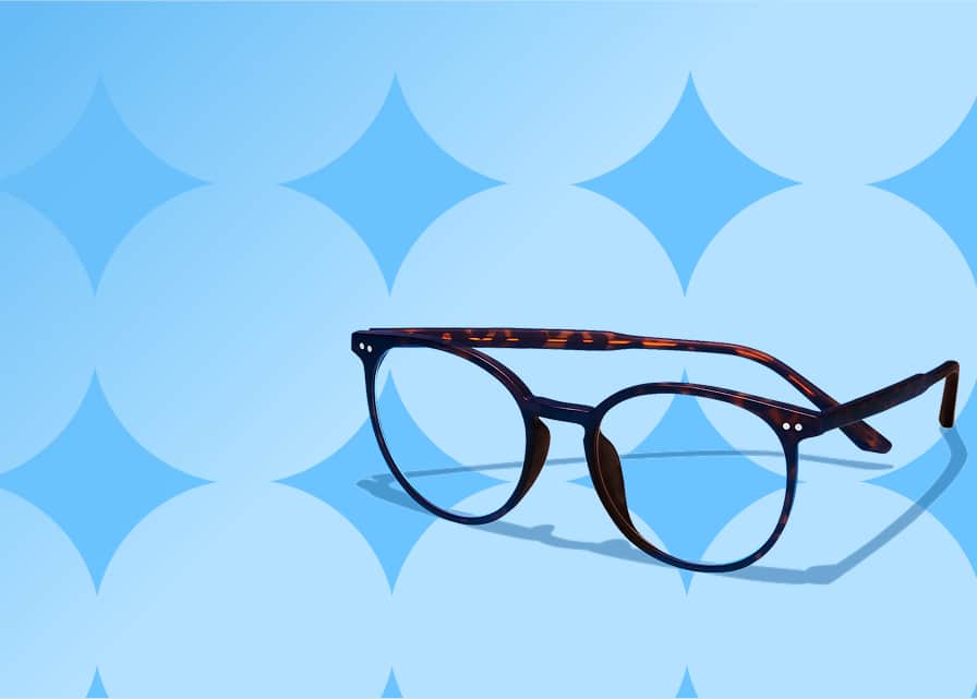 Tortoiseshell round glasses on a blue patterned background.