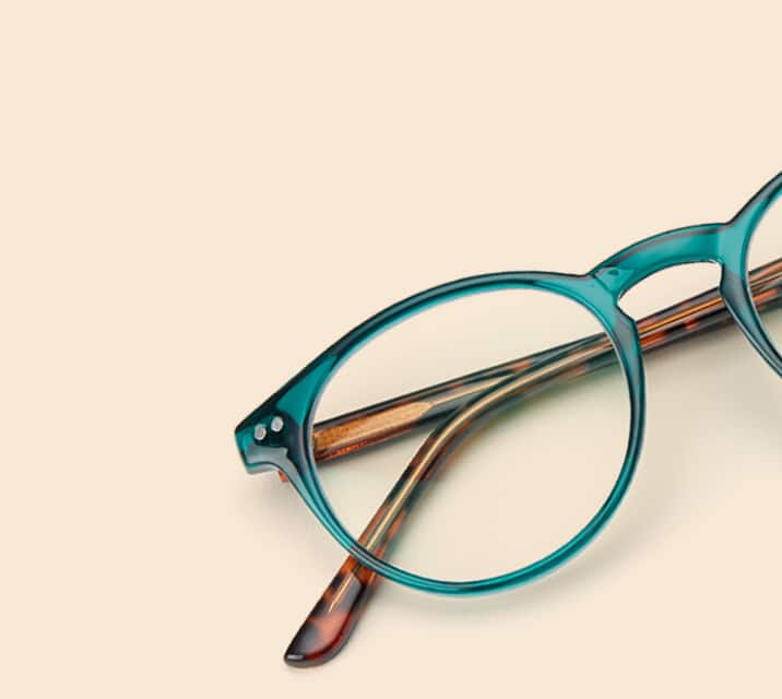 Image of Zenni green round glasses style #127424 shown with a light peach background.