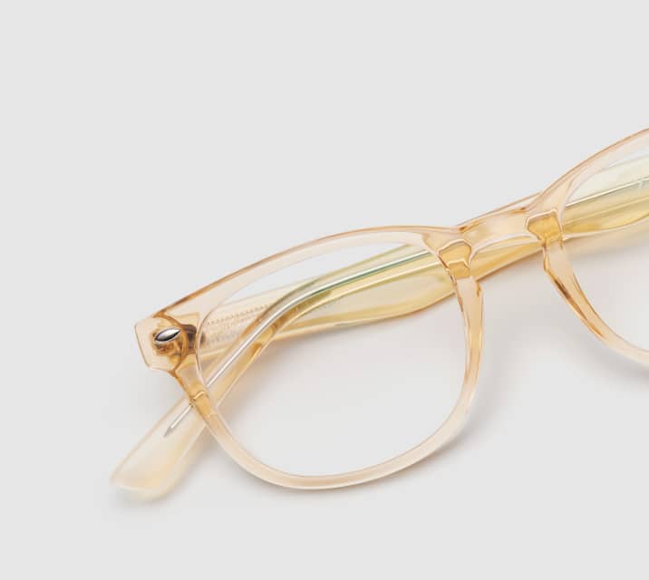 Image of Zenni yellow translucent oval glasses style #125922 shown with a light gray background.