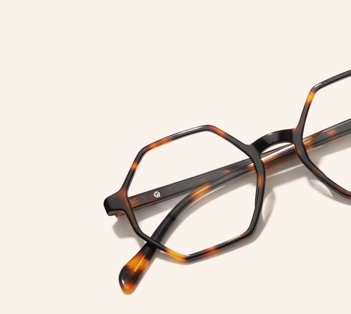 Image of Zenni geometric tortoiseshell glasses style #4442225 shown with a light peach background.