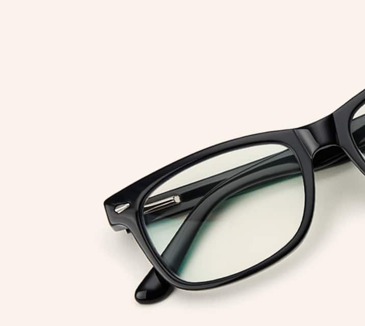 Image of Zenni black rectangle glasses style #612921 shown with a beige background.