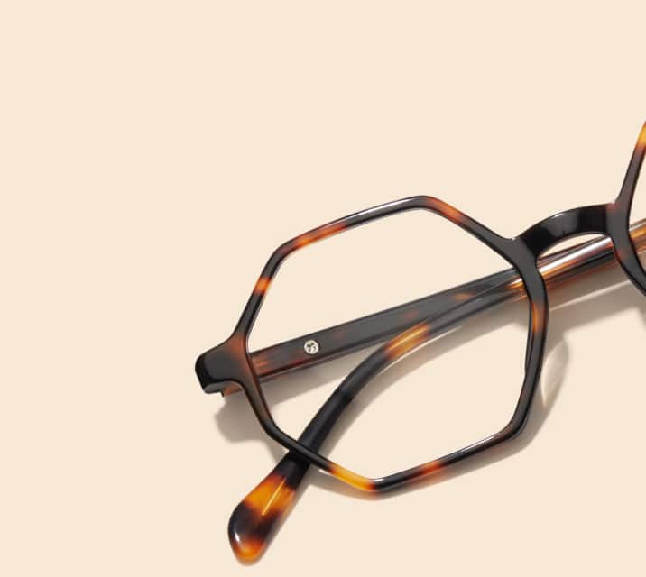 Image of Zenni geometric tortoiseshell glasses style #4442225 shown with a light peach background.