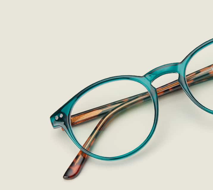 Image of Zenni green round glasses style #127424 shown with a light green background.