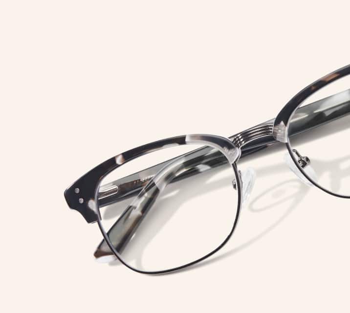 Image of Zenni black-patterned browline glasses style #199431 shown with a beige background. 
