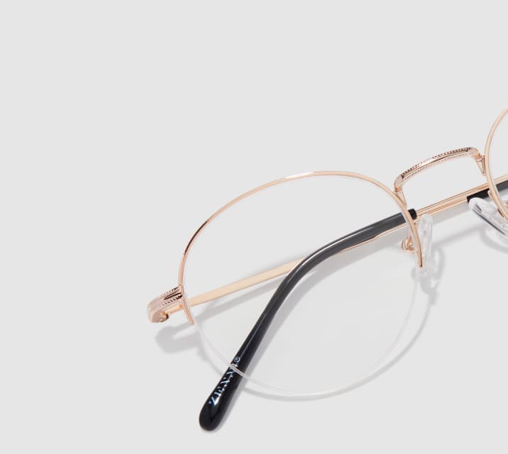 Image of Zenni gold browline glasses style #3224114 shown with a light gray background.