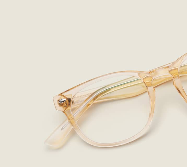 Image of Zenni yellow translucent oval glasses style #125922 shown with a light green background.