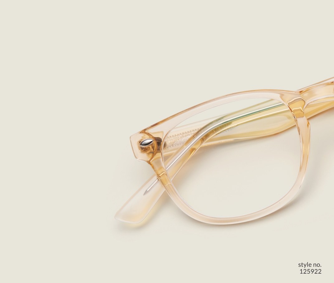 Image of Zenni yellow translucent oval glasses style #125922 shown with a light green background.