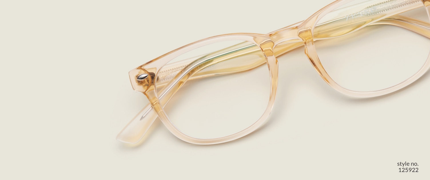 Image of Zenni yellow translucent oval glasses style #125922 shown with a light green background.