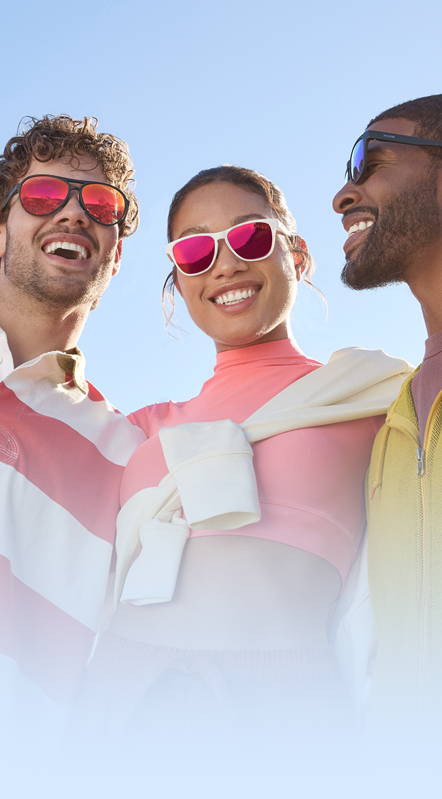 Two stylishly dressed men and a woman wearing various styles of Zenni sports sunglasses with mirror tint lenses. Blue sky background.