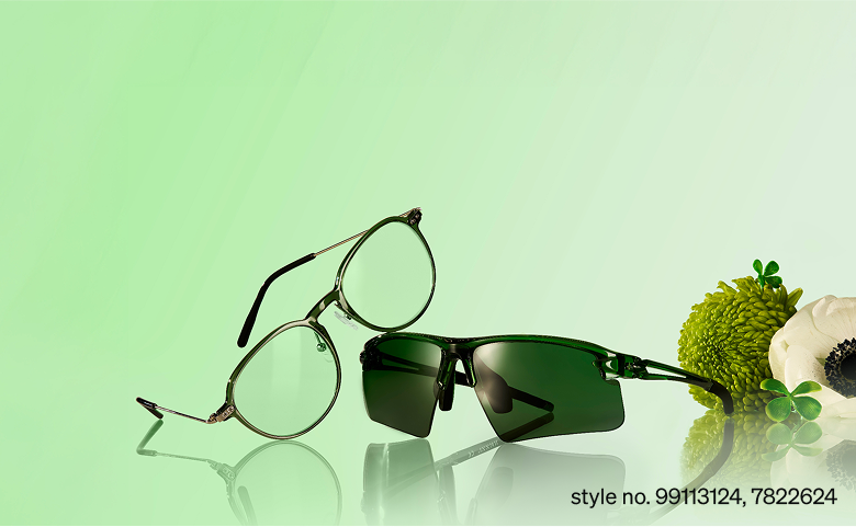 Green round glasses, style 7822624, and sport sunglasses with green-tinted lenses, style 99113124, are set against a soft green background with fresh greenery beside them.