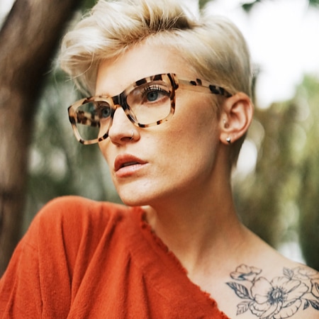 Alissa Laderer wearing Zenni Alamere square glasses #4413825 surrounded by a nature scene.