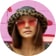 Ania Boniecka wearing zenni premium cat-eye sunglasses #1110919 in front of a pink-graffitied building.
