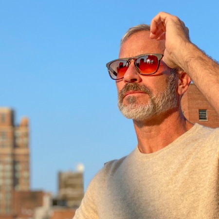Garrett Swann wearing zenni premium square sunglasses #113121 with the sun shining on his face.