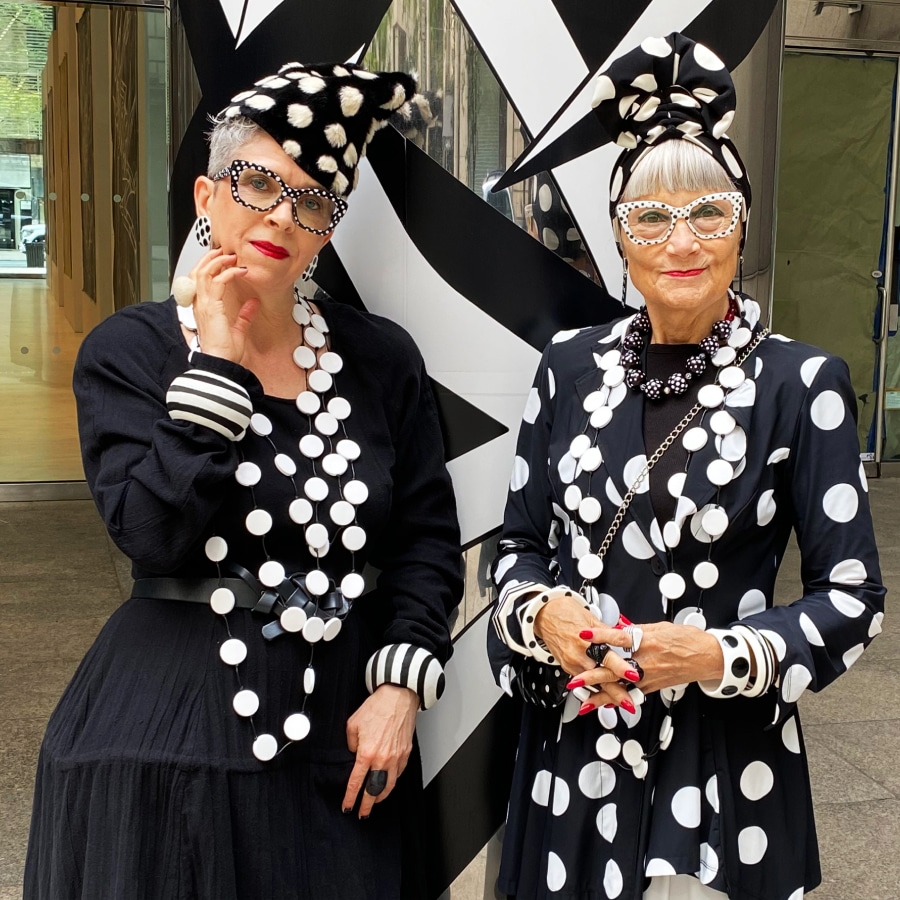 Image of two older ladies wearing black and white polka-dotted outfits and matching black and white polka-dotted glasses.