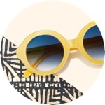 Zenni oval glasses #2023022 on a cream-colored background with tribal printed accents.
