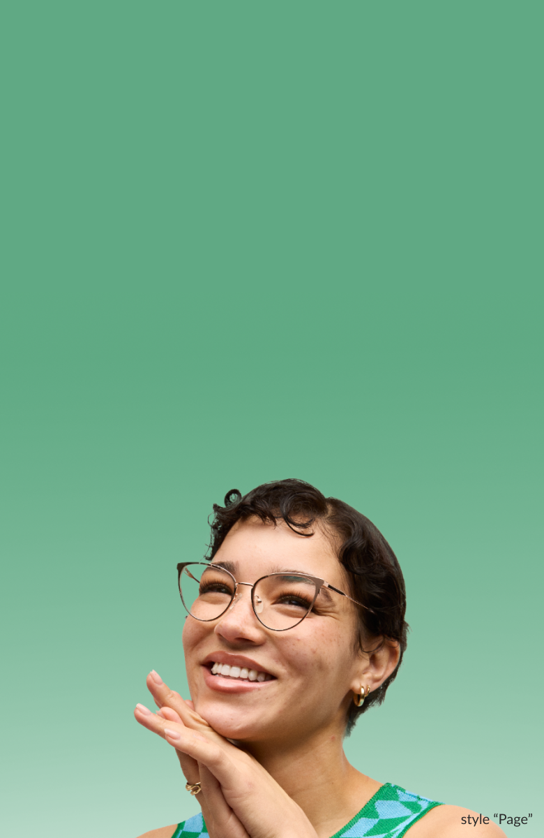 A smiling woman with short curly hair wearing cat-eye style “Page” Timo x Zenni glasses against a light green background.