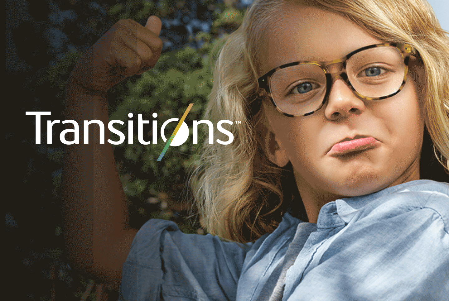 Image of a kid wearing glasses with Transitions lenses in them.