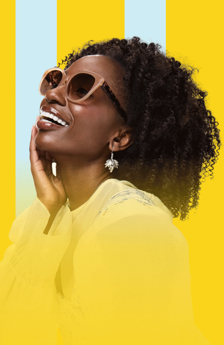 Three smiling people posing together in stylish eyeglasses and sunglasses against a backdrop of bold yellow and light blue vertical stripes.