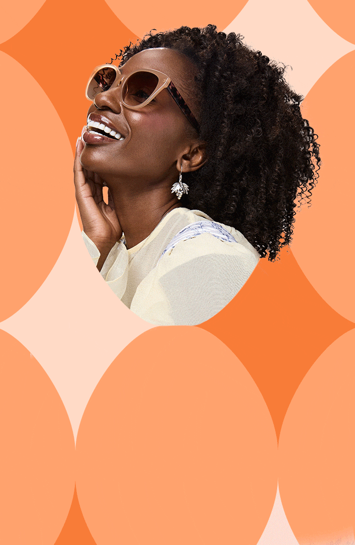 Three smiling people wearing trendy glasses pose in front of an orange patterned background — one with pink round sunglasses and white hair bows, another in dark square frames, and a third in oversized beige sunglasses with curly hair.