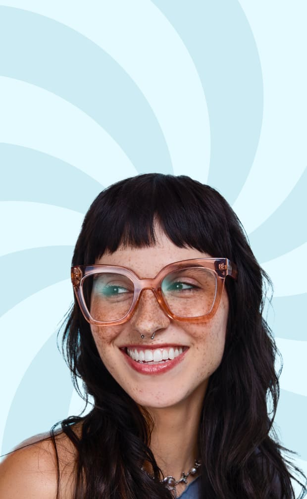 Woman wearing oversized Zenni pink translucent glasses smiling wide.