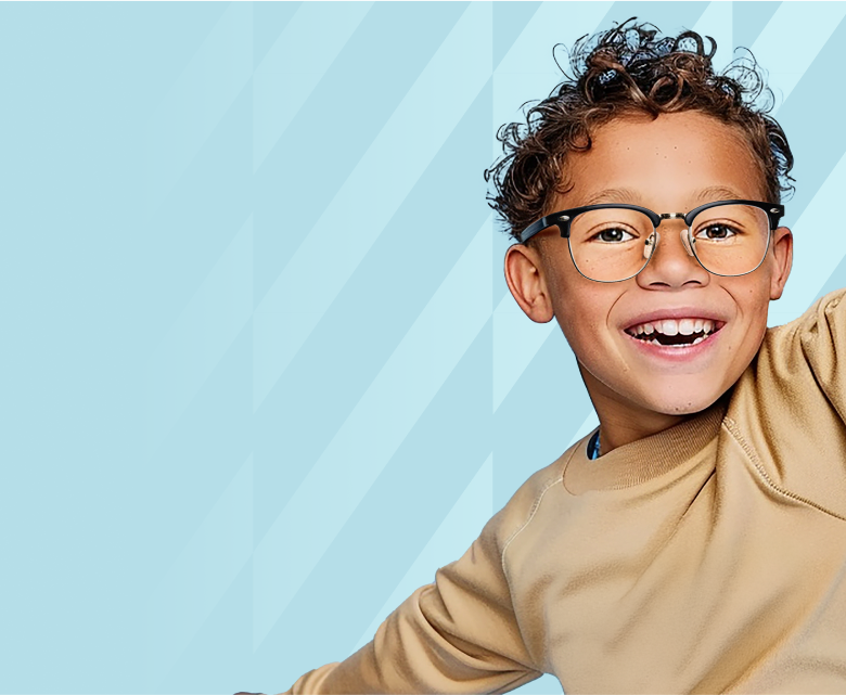 A cheerful child with curly hair wearing black browline glasses.