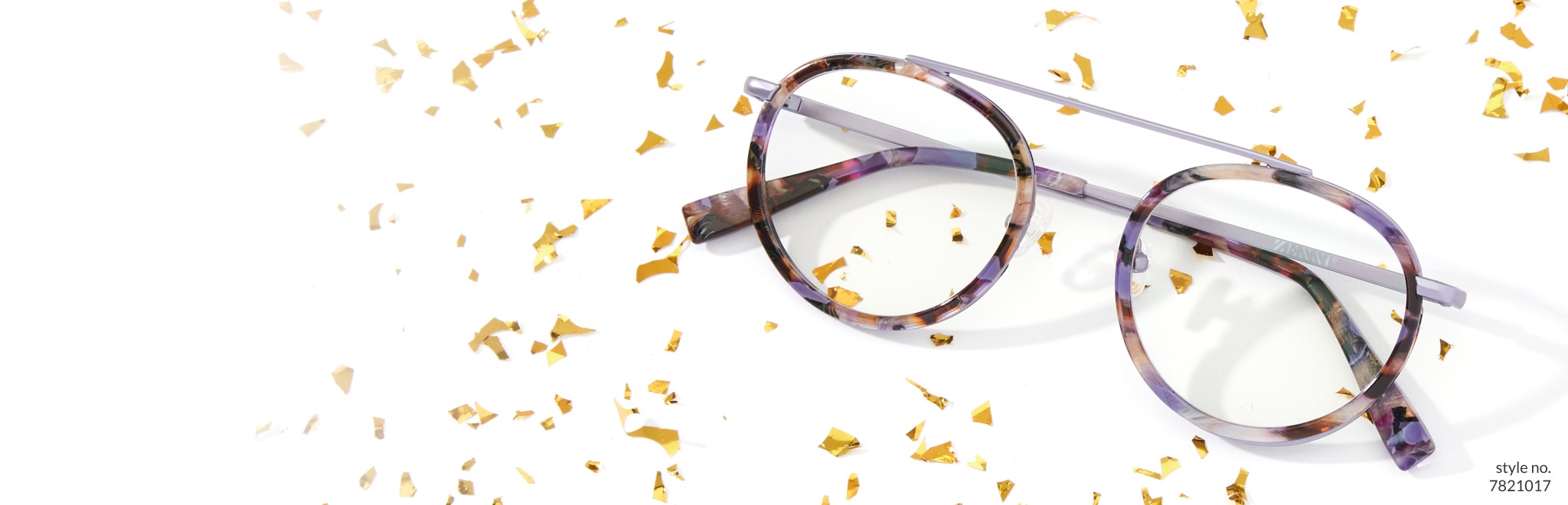 Image of Zenni round glasses #7821017 against a white background, with gold glitter sprinkled all around them.