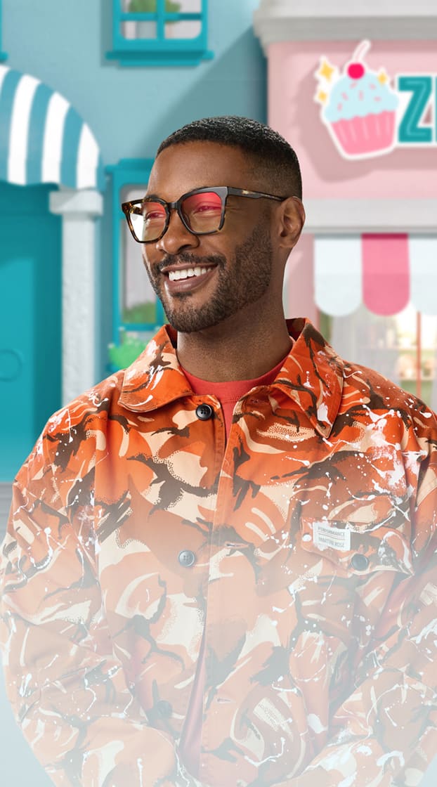Man wearing Zenni dark-framed glasses with slightly tinted lenses in a stylized Zenniverse lifestyle setting.