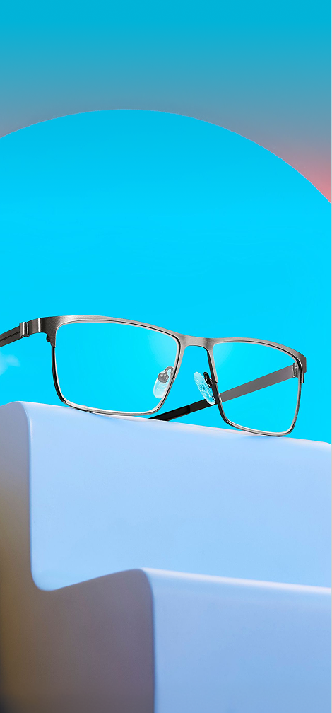 Zenni glasses in rectangular metal frames displayed on a lavender riser with a sky blue background