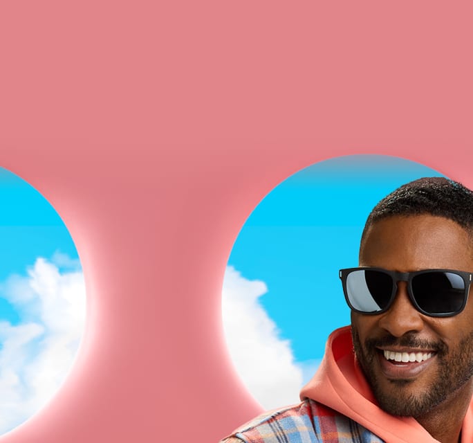 Man wearing Zenni dark-framed glasses with tinted lenses in a stylized Zenniverse lifestyle setting.