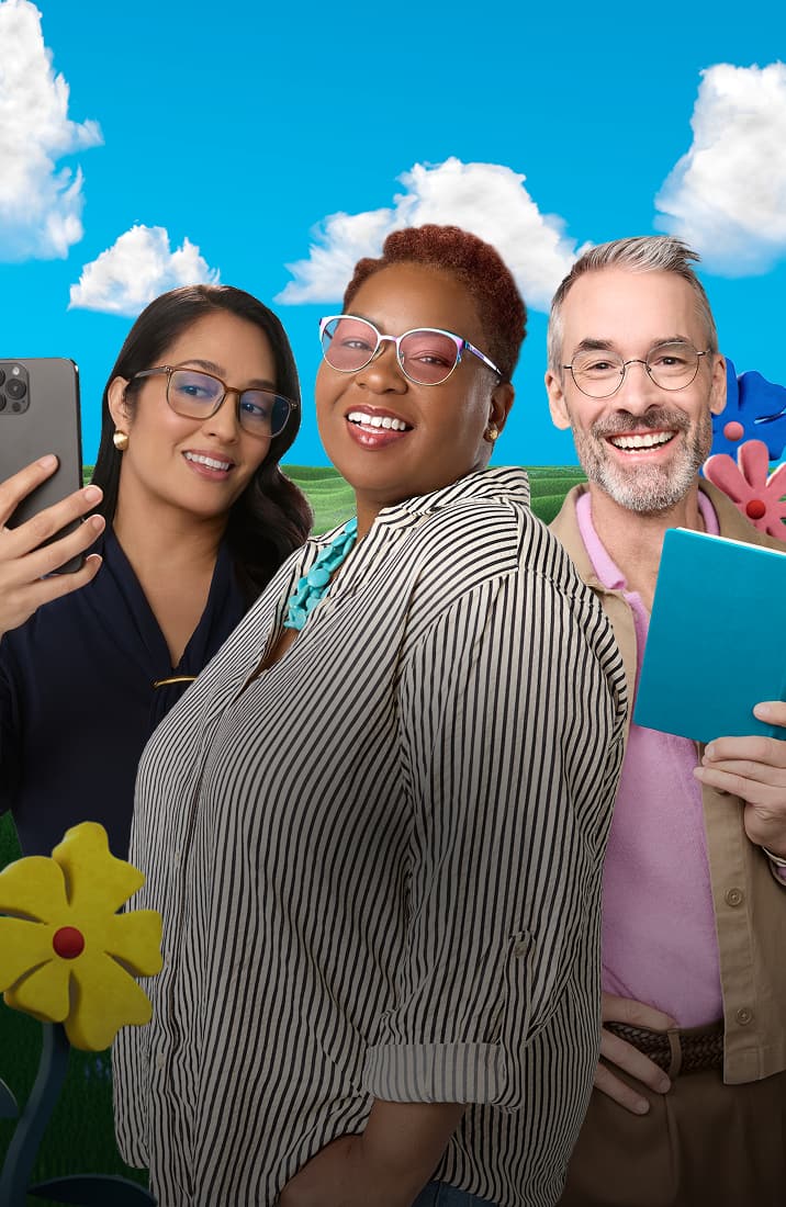 Three smiling people wearing prescription glasses stand together in a playful, cartoonish landscape with green rolling hills, large colorful toy-like flowers, and a blue sky; one woman holds a smartphone, and a man holds a small blue book.