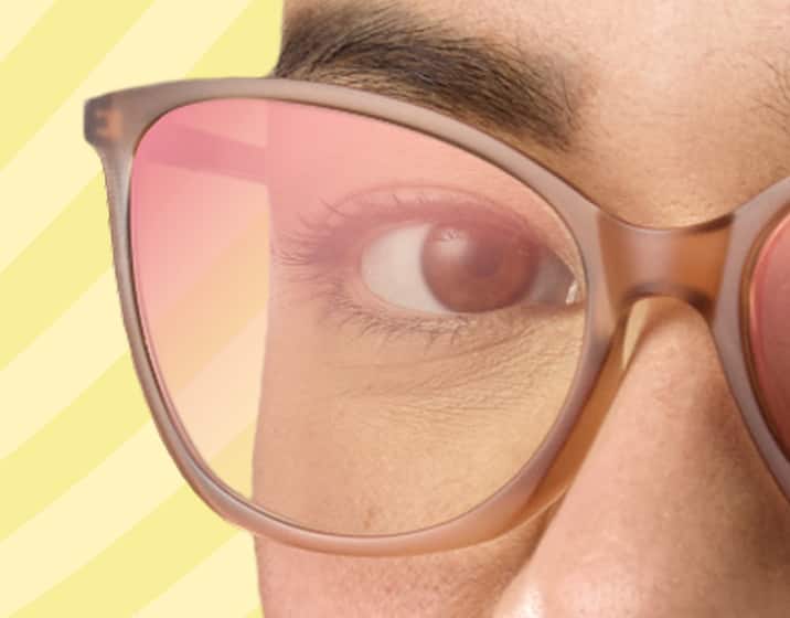 Close up of a woman wearing brown translucent cat-eye Zenni glasses with EyeQLenz with Zenni ID Guard lenses that are clear indoors with a slight magenta reflective sheen.