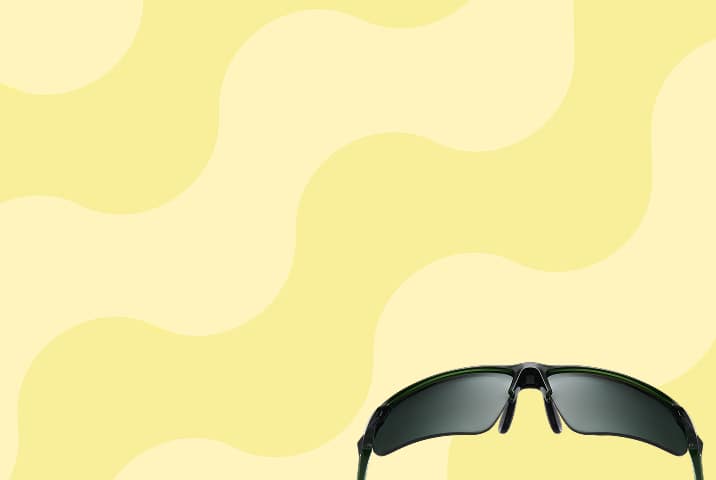 Black wraparound Zenni sports sunglasses with dark gray lenses. Yellow wavy stripe background.