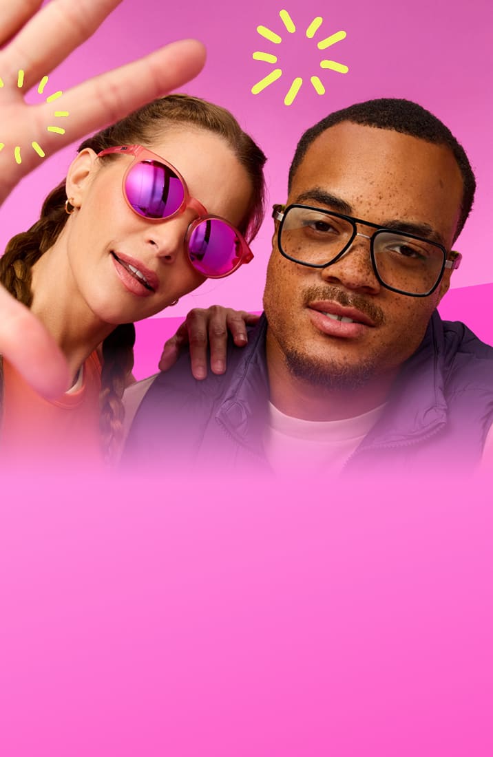 Two people pose playfully against a bright pink backdrop. One wears pink reflective sunglasses and an orange tank top; the other wears black glasses, a white shirt, and a purple vest. Both gesture toward the camera under yellow doodle sparkles.